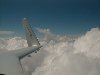 
              Winging along at 11,500 feet over Georgia

My Cozy is N23CZ, plans number 108.  It was built in Burbank, CA and first flew in October, 1988.  I purchased it from the original builder in August, 1998 with just over 500 hours on the engine and airframe.  I've flown from my home base at Houston Southwest Airport (KAXH), TX to Oshkosh, Sun 'n Fun twice and have made numerous trips to Augusta, GA and Tampa, FL to visit family and friends.  I now have over 750 hours on the 150 HP Lycoming O-320-E2A and Great American prop.

The plane is IFR equipped with Narco Nav/Com's, Loran and Transponder. Of course my Garmin GPS 195 handles most of the navigation chores nowadays. 

The plane was built to plans and has an empty weight of 997 pounds.  It has a max speed of 180 KTAS at 2700 RPM but I usually cruise at a comfortable 2450 RPM which gives me a TAS of 150 KTS on 7.5 gph.

I am a former Navy carrier pilot and think that sliding into the Cozy is the next best thing to being back in a military cockpit.  It is a pleasure to fly and a lot of fun on 7.5 gph! Richard Reitz, Houston, TX